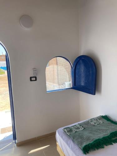 a room with a bed and a window on the wall at Dolphin Camp in Dahab