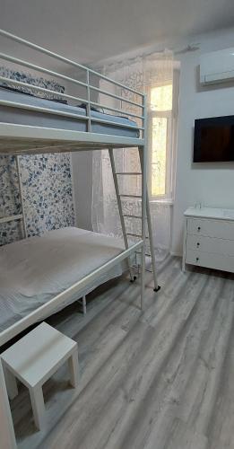 a room with two bunk beds and a desk at ON BOARD in Piran