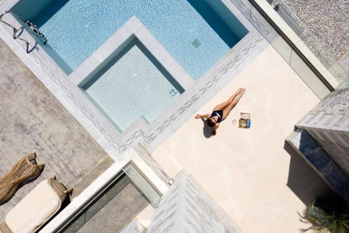 an overhead view of a woman swimming in a pool at ViveVerde Villa, featuring 3 Pools - Walking distance to Beach & Shops, By ThinkVilla in Balíon