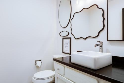 a bathroom with a white toilet and a sink at Entire condo in downtown winston in Winston-Salem