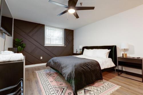 a bedroom with a bed and a ceiling fan at Entire condo in downtown winston in Winston-Salem