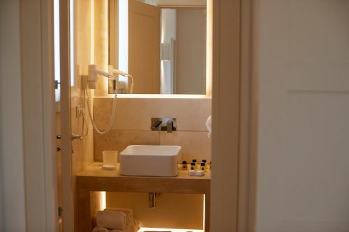 a bathroom with a sink and a mirror at Montiro' Hotel in Leuca