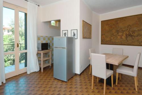 a kitchen and dining room with a table and a refrigerator at La Piccola Bellagio in Bellagio
