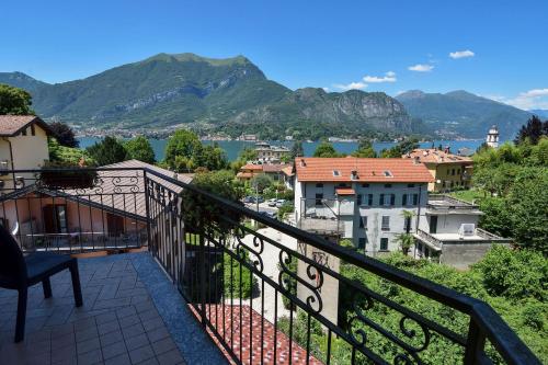 a balcony with a view of the water and mountains at La Piccola Bellagio in Bellagio