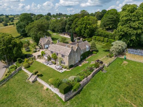 an aerial view of an old castle with trees at Winstone Glebe in Cirencester