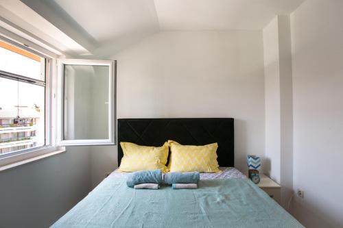 מיטה או מיטות בחדר ב-Little Max Apartment