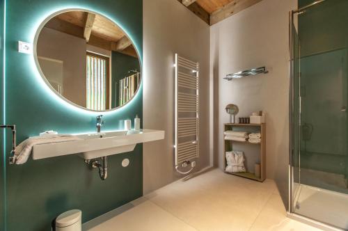a bathroom with a sink and a mirror and a shower at Studio na Stolbi in Ljubljana