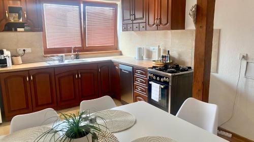 a kitchen with a table and chairs and a stove at Sunny Attic Apartment in Zvolen