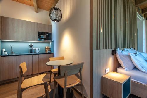a room with a bed and a table and chairs at Studio na Stolbi in Ljubljana