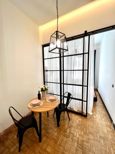 a dining room with a table and chairs and a window at Krosno4YOU in Krosno