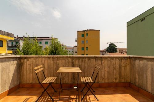 d'une table et de deux chaises sur un balcon. dans l'établissement La Tana al sole, à Brescia