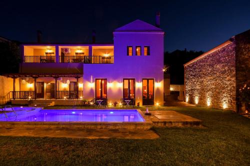 a house with a swimming pool at night at Guesthouse Amanitis Caesarea in Skíti