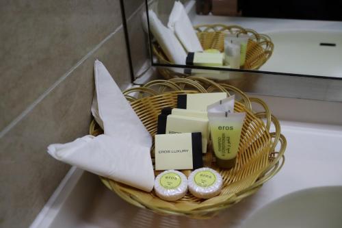 a basket filled with soap and other items on a toilet at GSS Palace Hotel in Dubai