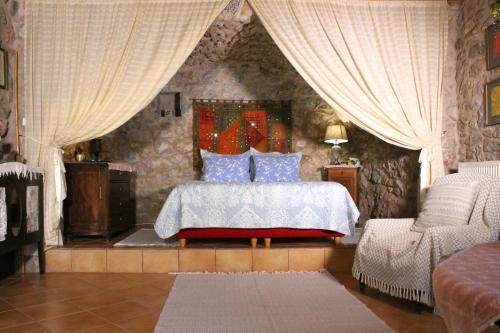 a bedroom with a bed with blue pillows at Traditional stone build private studio in Verga Kalamata