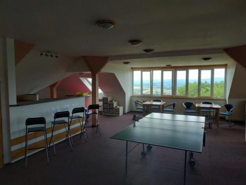 a large room with a table and chairs in it at Hotel Vyhlídka in Lomnice nad Popelkou