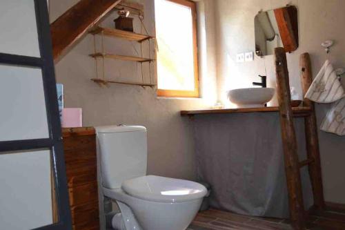 uma casa de banho com um WC e um lavatório em Grange rénovée où l’on s’y sent bien ! em Chorges