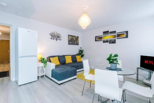 a living room with a couch and a table at 1BR & 2BR Apt -for CONTRACTORS- free PARKING close to EVERTON & ANFIELD stadium, Liverpool City Centre managed by Chique Properties Ltd in Liverpool