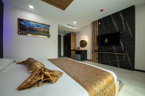 a bedroom with a large bed and a shower at Air Barbaros Hotel Trabzon in Trabzon