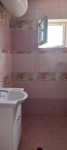 a bathroom with a sink and a glass shower at Casa Branca in Sozopol