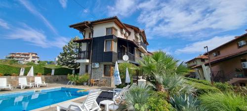 a villa with a swimming pool and a house at Sani Holiday Village in Sozopol