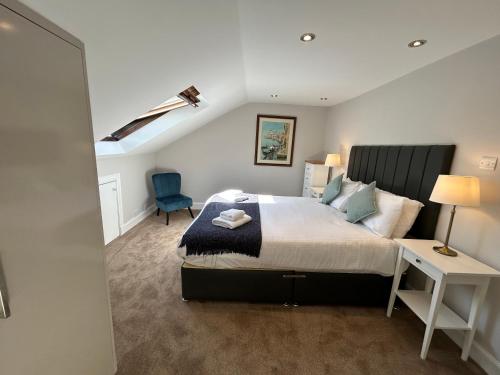 a bedroom with a bed and a desk and a chair at Principal Apartments - Crown Circus Duplex Apartment in Glasgow