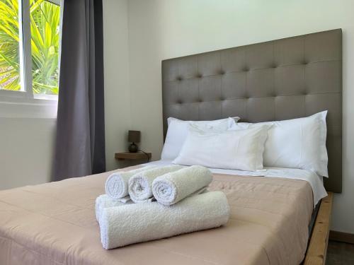 a bedroom with a large bed with towels on it at Quinta da Joia in Silves