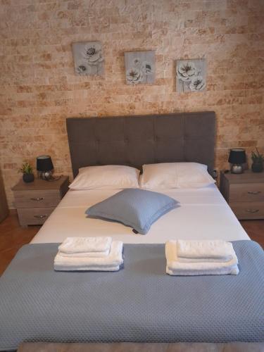 a bedroom with a large bed with towels on it at Harmony in Lávrion
