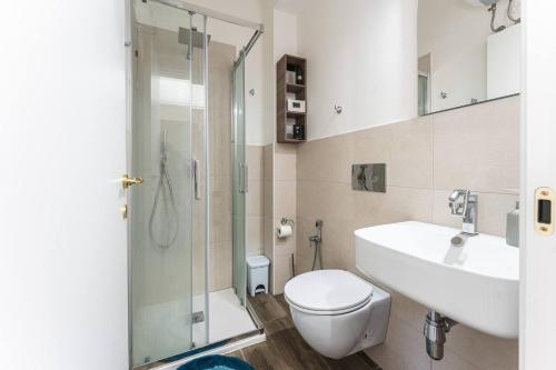 La salle de bains est pourvue de toilettes, d'un lavabo et d'une douche. dans l'établissement SeRa Suite, à Cagliari
