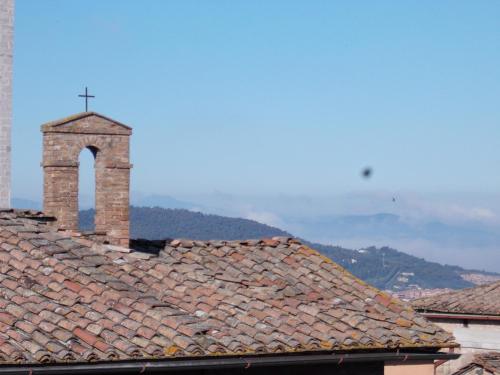 a tile roof with a cross on top of it at Primavera Mini Hotel in Perugia
