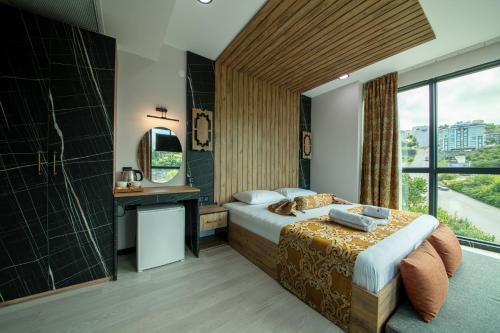 a hotel room with a bed and a window at Air Barbaros Hotel Trabzon in Trabzon