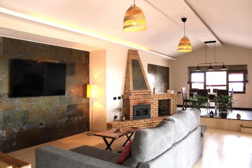 a living room with a couch and a fireplace at Eco Terra by Sea You There Fuerteventura in Puerto del Rosario