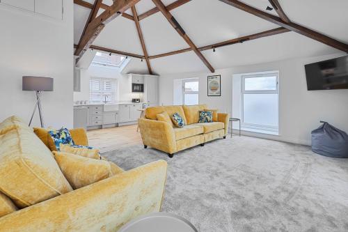 a living room with two couches and a kitchen at Host & Stay - 3 The Mount in Whitby