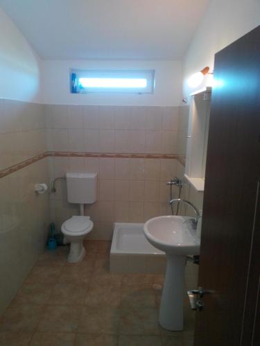 a bathroom with a toilet and a sink and a tub at Vila Antonia in Eforie Nord