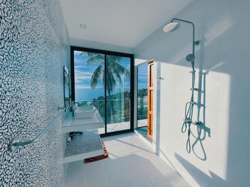 a bathroom with a shower and a sink and a mirror at Villa Valentin in Salad Beach