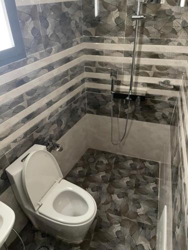 a bathroom with a toilet and a shower at Studio meublé Centre-ville Dakar in Dakar