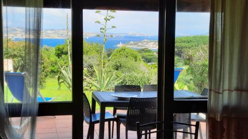 a view of a table and chairs from a window at Welcomely - Porto Rafael Apartments in Palau
