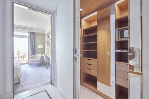 a door leading into a room with a bedroom at Hôtel Martinez, in The Unbound Collection by Hyatt in Cannes