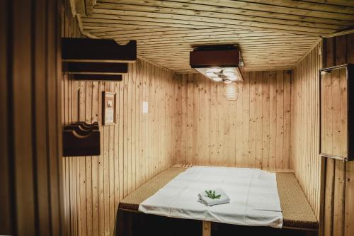 a room with a bed in a wooden room at Chalet Magdalena in Avelengo