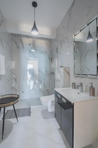 a bathroom with a sink and a toilet and a mirror at Villa Krstac in Budva