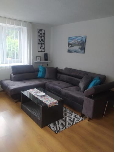 a living room with a couch and a coffee table at Apartmán Karin in Huty