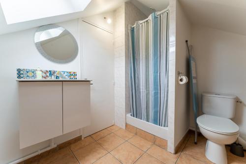 a bathroom with a toilet and a shower at Poissy - Ma Résidence Privée in Poissy