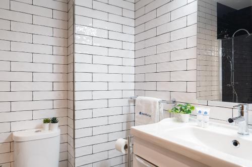 a white bathroom with a toilet and a sink at Host Wise - Fantastic Peaceful Flat in Gaia in Vila Nova de Gaia