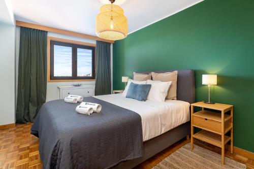 a bedroom with a bed with two towels on it at Host Wise - Fantastic Peaceful Flat in Gaia in Vila Nova de Gaia