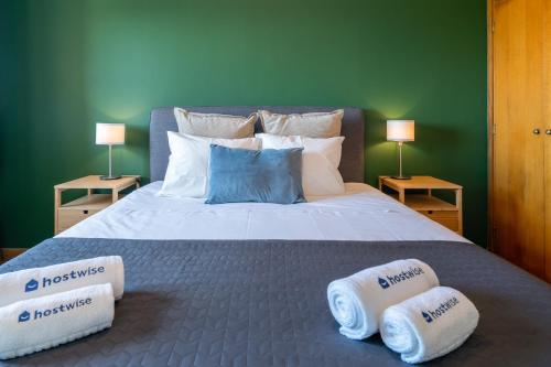 a bedroom with a bed with two towels on it at Host Wise - Fantastic Peaceful Flat in Gaia in Vila Nova de Gaia