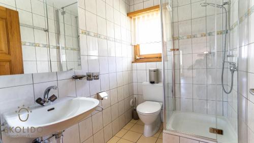 a bathroom with a sink and a toilet and a shower at Ferienwohnung Chalet Bortelhorn in Termen