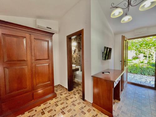 a home office with a wooden door and a desk at Hotel Opera Jaz in Budva