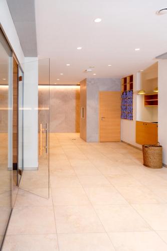 a hallway with a tile floor and a glass door at FischerS in Kassel