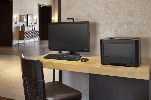 a desk with a computer monitor and a printer at Residence Inn by Marriott Santa Barbara Goleta in Santa Barbara