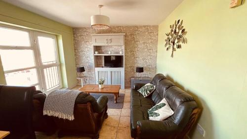a living room with a couch and a table at Bundoran Seaview Apartments in Bundoran
