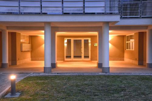 a building with columns and a candle in the grass at Bloom Apartment in Pero